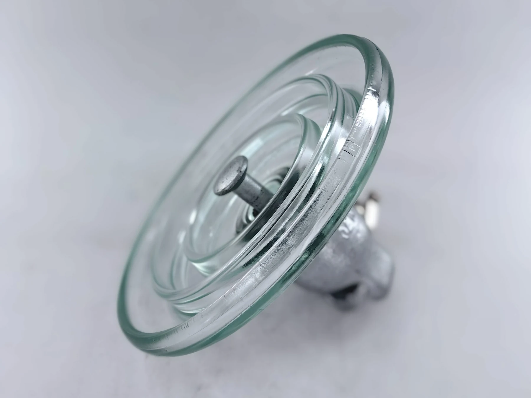 Standard type U70B toughened glass suspension insulator photographed from a low angle