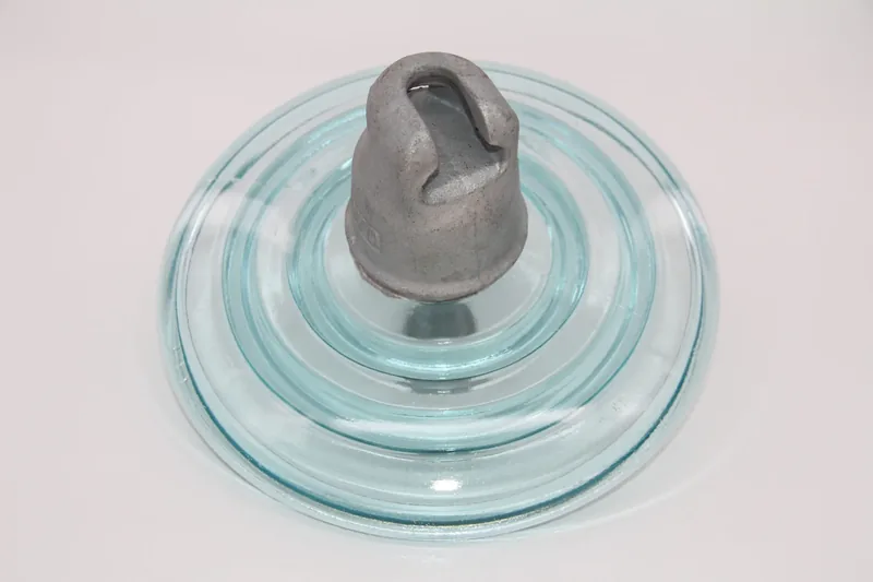 Toughened glass insulator showing the cap that handling loads should go through