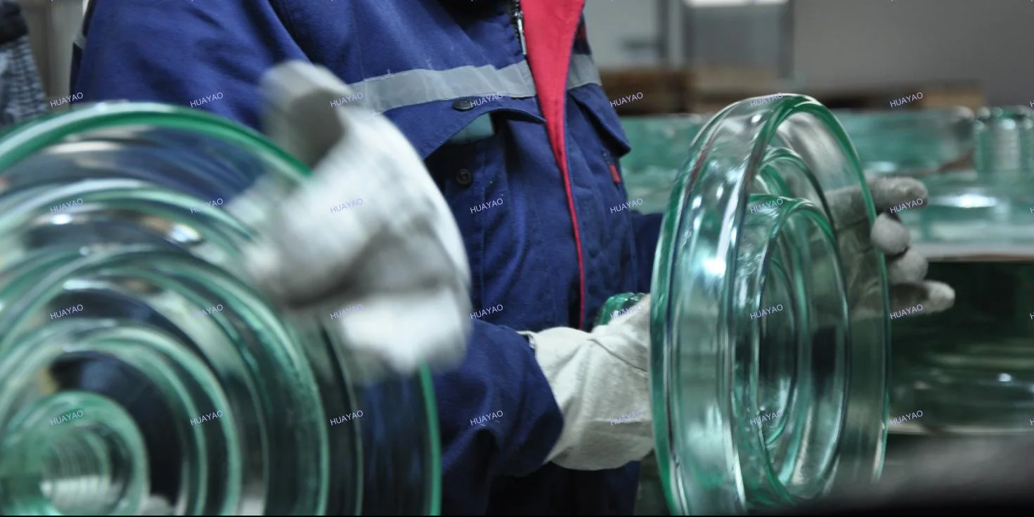 Huayao operator handling toughened glass insulator shells in the workshop