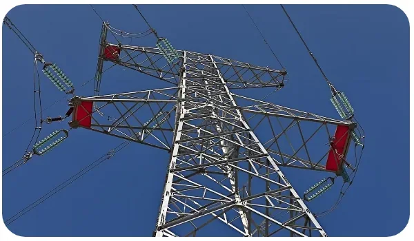 Transmission tower carrying insulator strings against a clear sky