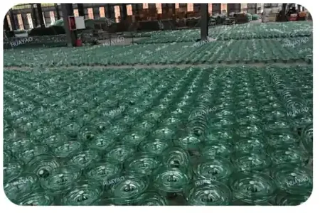 Anti fog profile toughened glass insulator shells stacked in the workshop