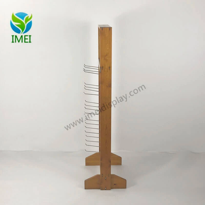 Metal hooks mounted on the wooden base of a banana store rack