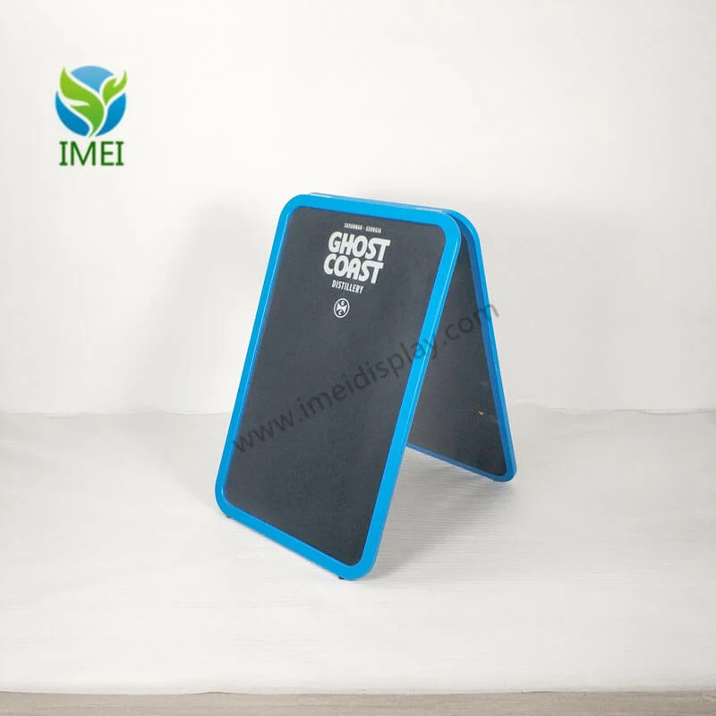 Blue edge ghost chalkboard standing open on a workshop floor with the ghost cutout visible