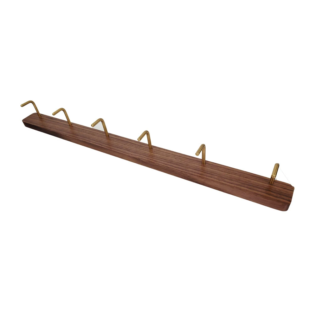 Freestanding clothes rack with rounded backplate standing in a showroom