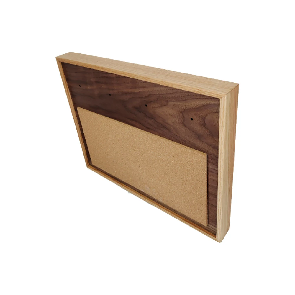 Wall-mounted wooden pinboard with linen fabric surface, displayed in a home office setting