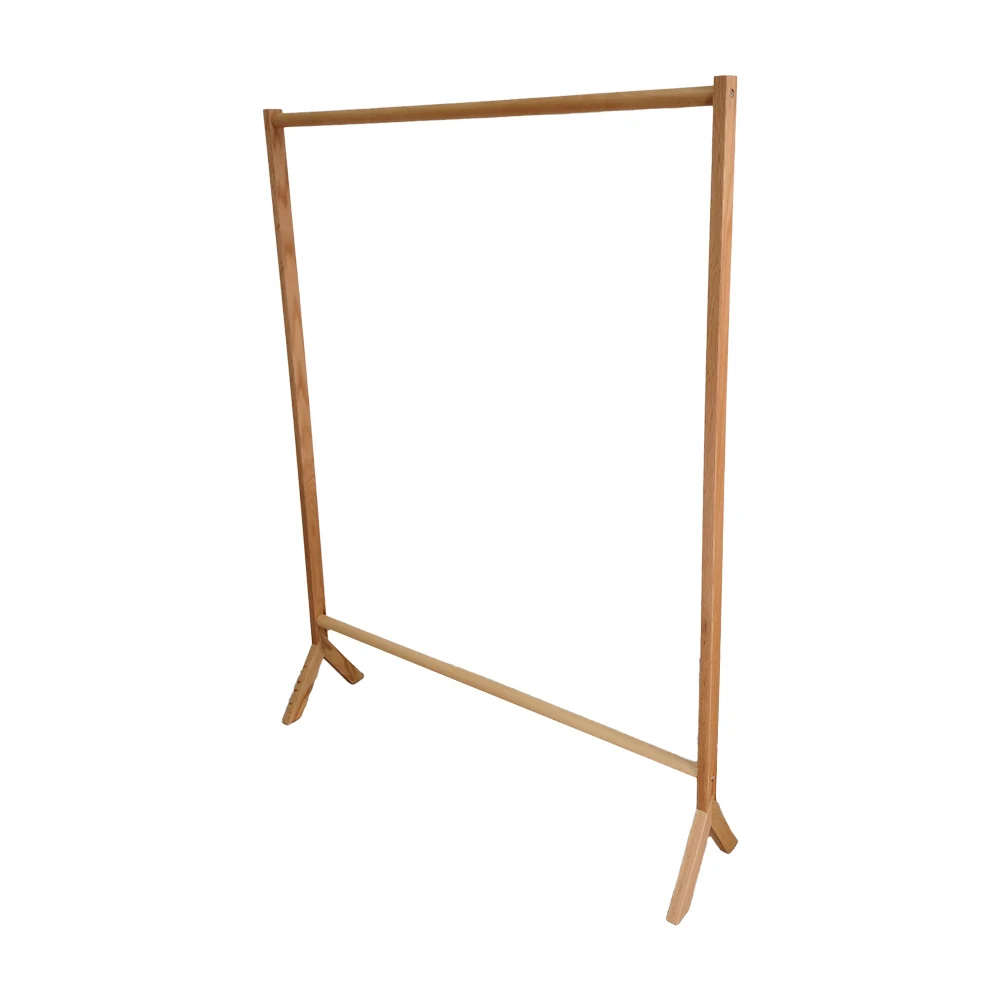Bamboo clothing rack standing upright with a hanging rod and ratten shelf at the bottom