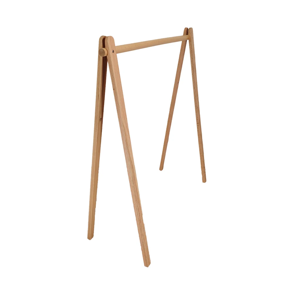 Freestanding clothes rack with wooden frame and metal supports in a retail workshop
