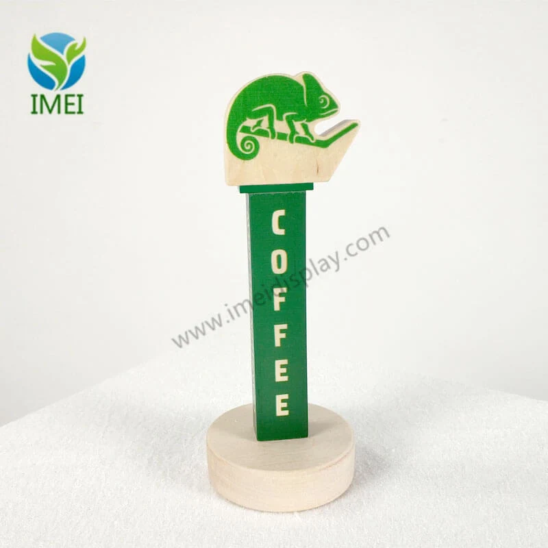Wood tap handle with UV-printed logo and stained surface under workshop lighting