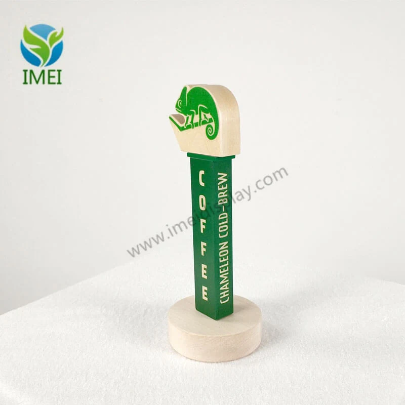 Close-up of a custom wood tap handle with laser-cut branding and natural finish
