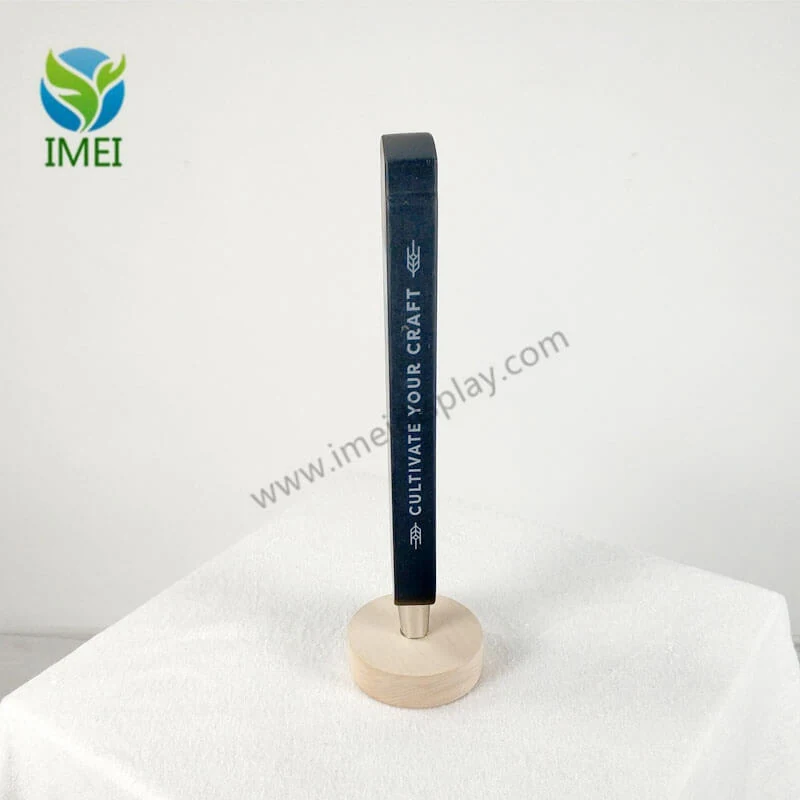 Wooden tap handle mounted on a tap valve in a bar setting
