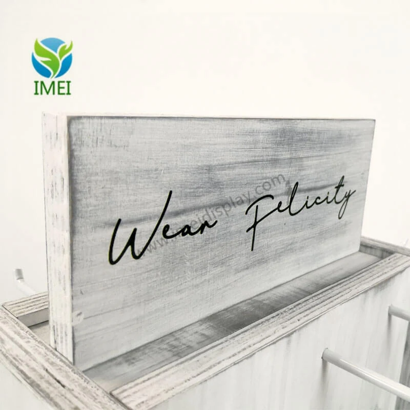 Whitewashed wooden counter display panel with a printed brand mark