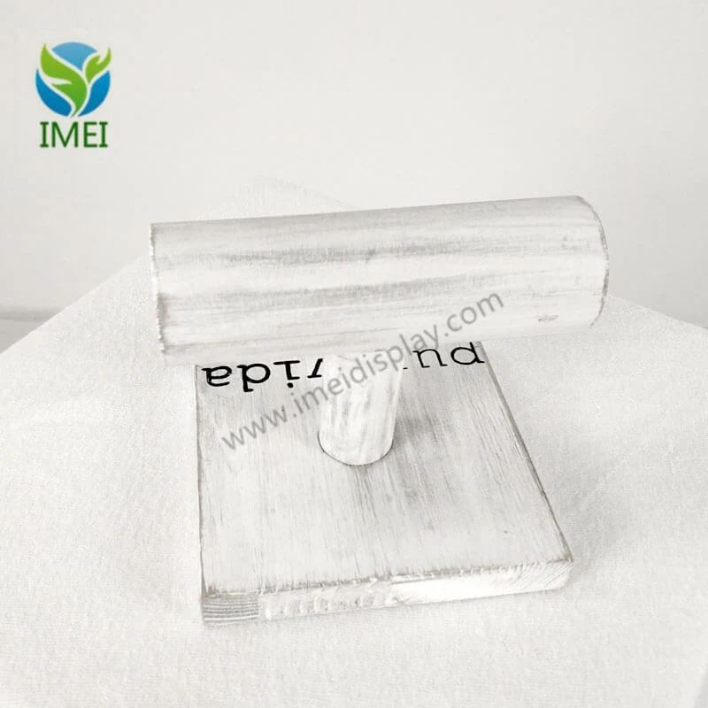 Close-up of UV-printed logo on a wooden panel of a jewelry counter display
