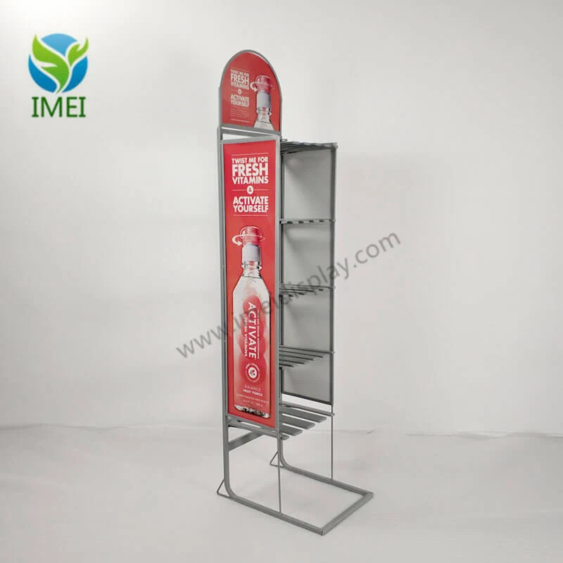 Vitamins metal floor display standing upright in a retail environment with printed logo panel visible