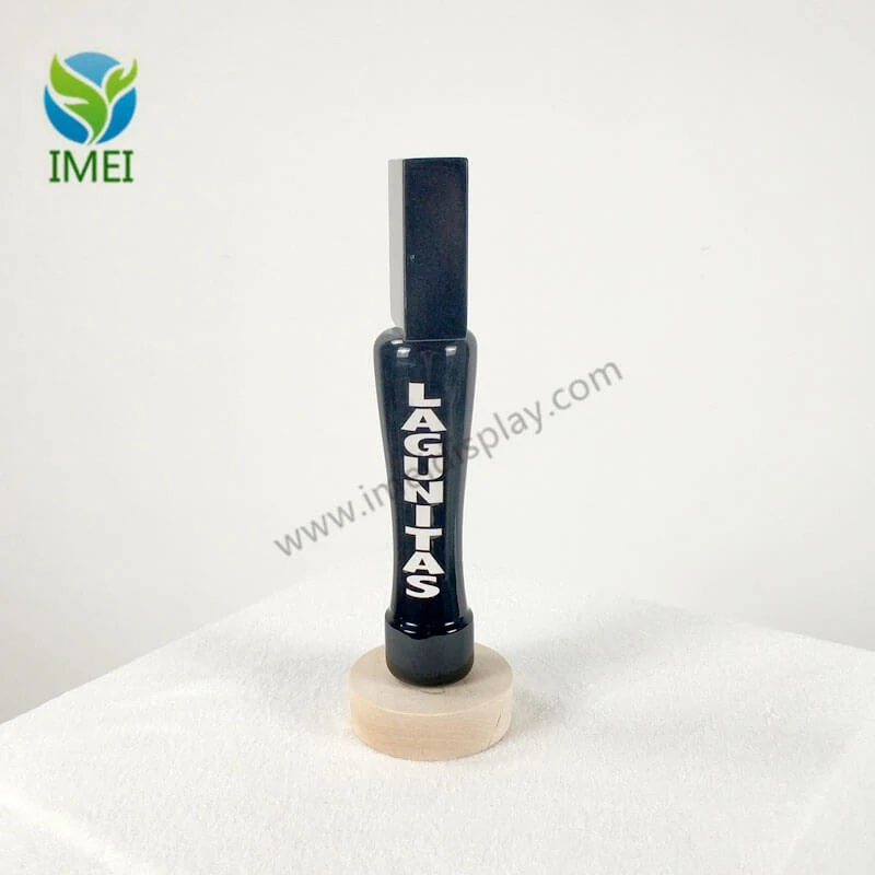 Wooden tap handle shown from the side with laser-cut detail visible