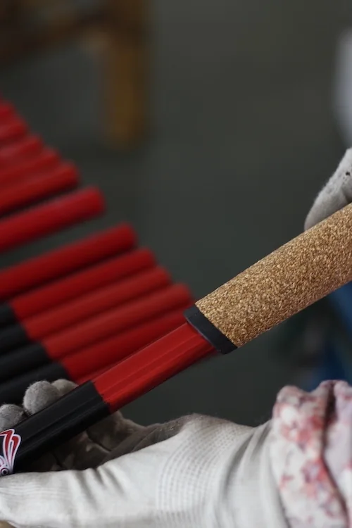 EVA and cork grips being fitted to trekking pole shafts