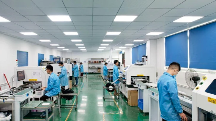 Operators testing finished LED modules on the production line