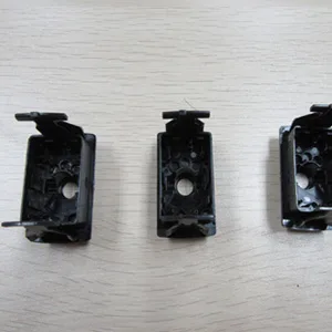 Three black molded housing halves laid out for inspection