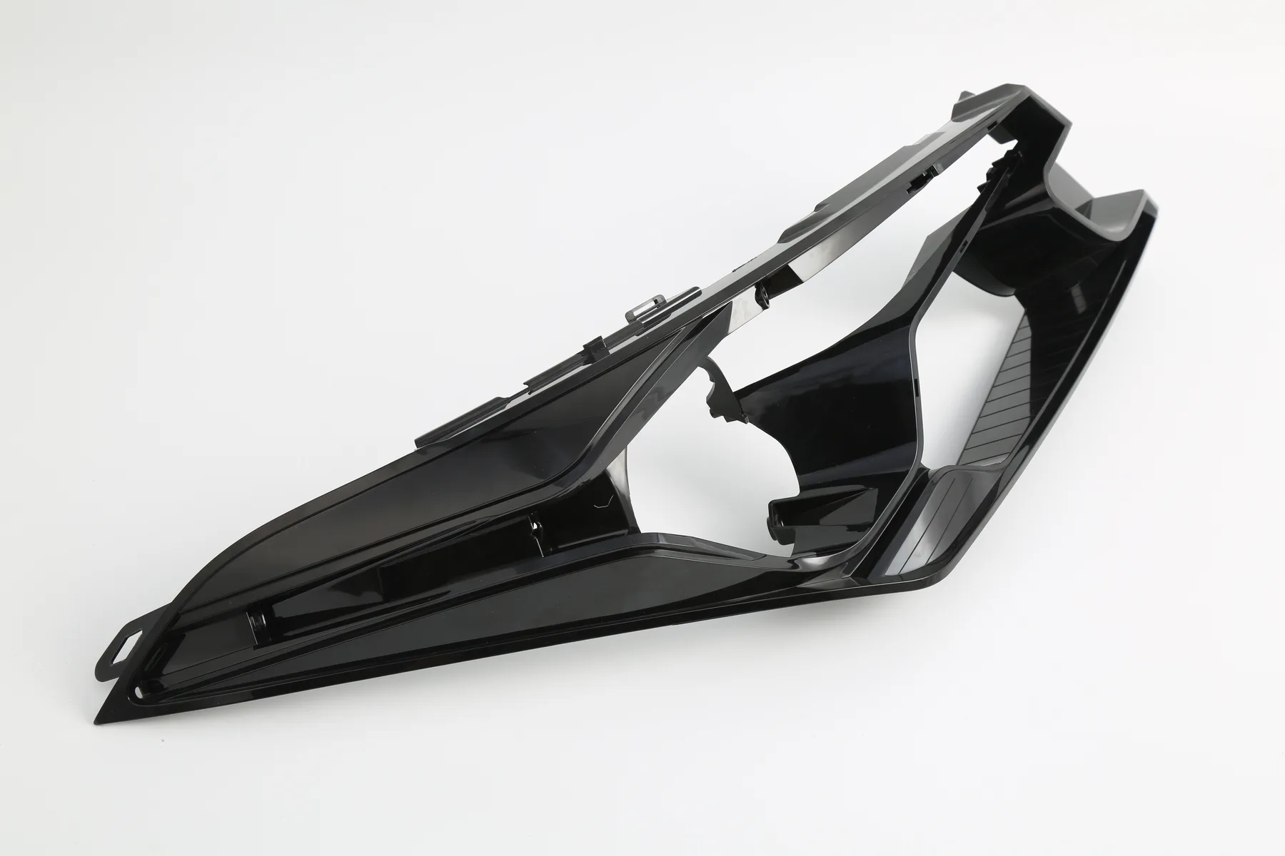 Black molded housing part photographed in the shop