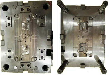 Two halves of an injection mold opened on the bench