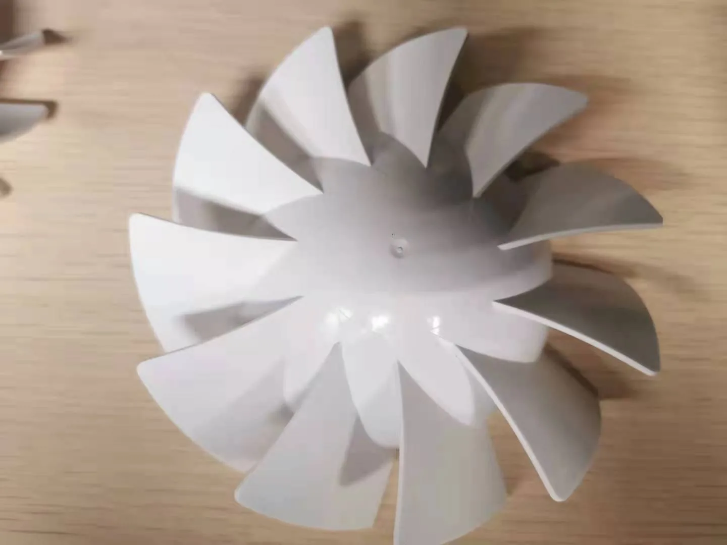White molded fan impeller with thin curved blades