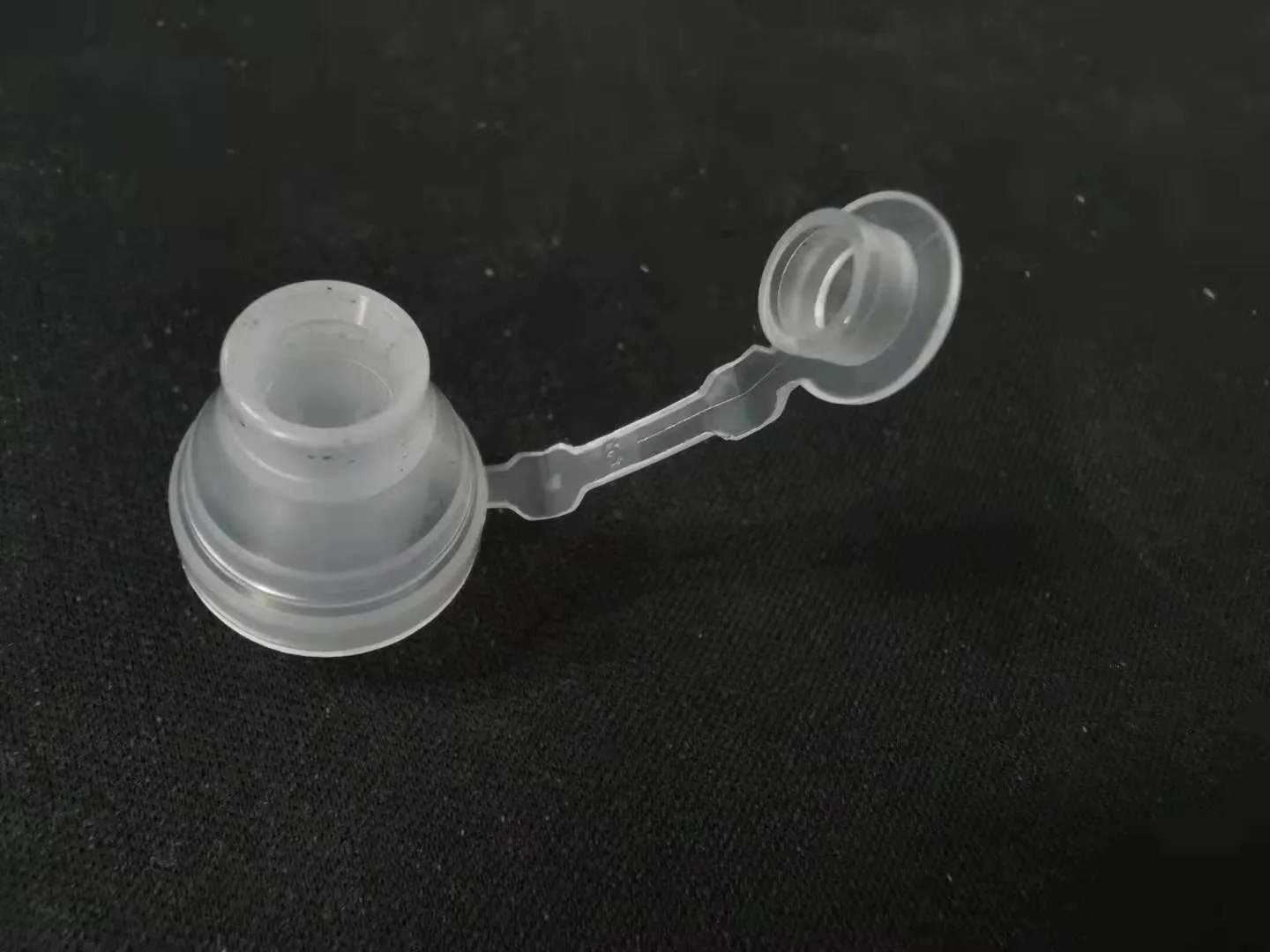 Molded port fitting with a tethered closure cap