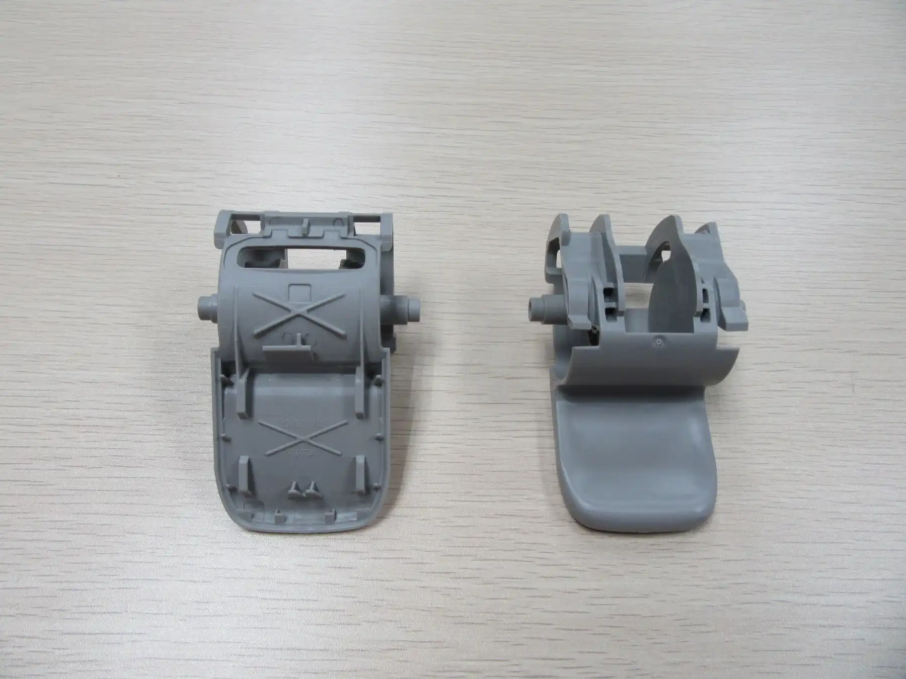 Two grey molded housing parts side by side