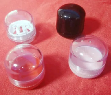Clear and black molded caps and lids together