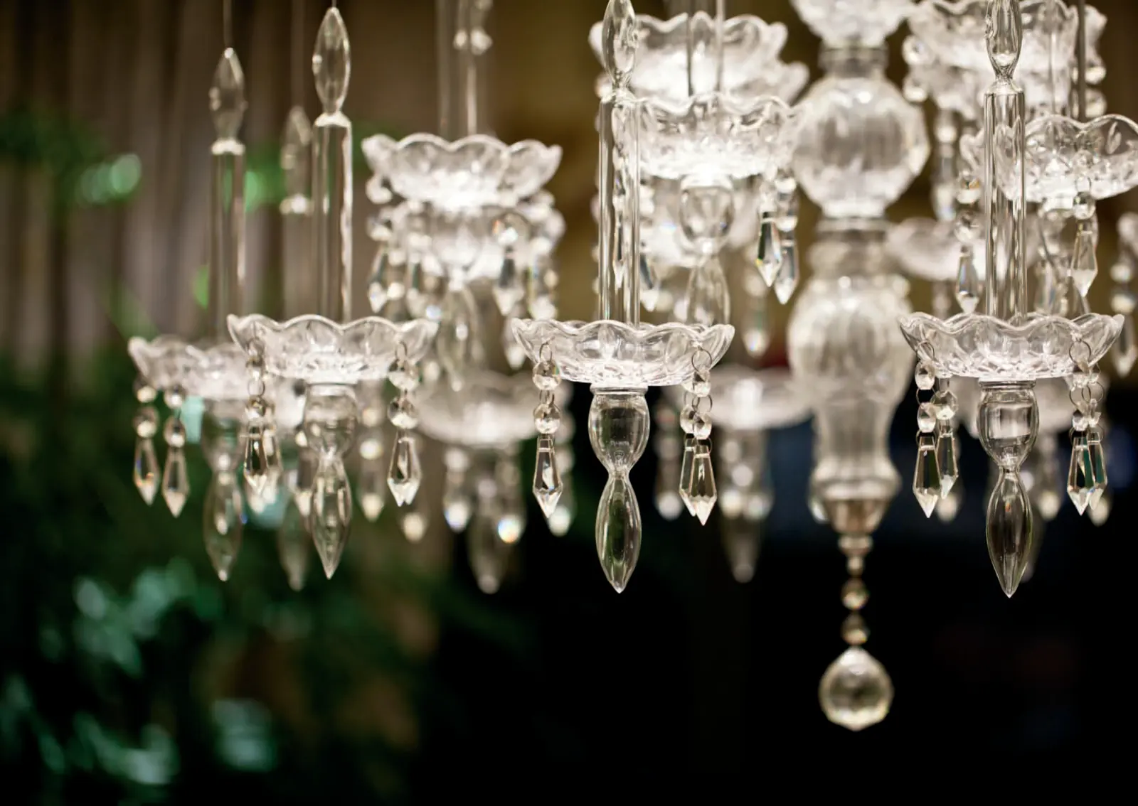 Close view of clear crystal chandelier arms with cut glass drops