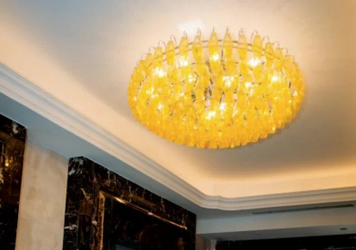 Large amber glass flush ceiling light set into a recessed ceiling