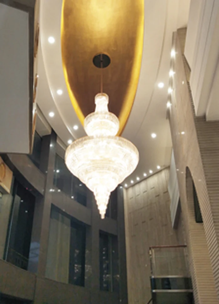 Alabaster pendant hanging under a gold domed ceiling recess