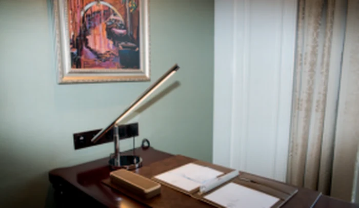 Slim task lamp on a writing desk in a hotel guest room