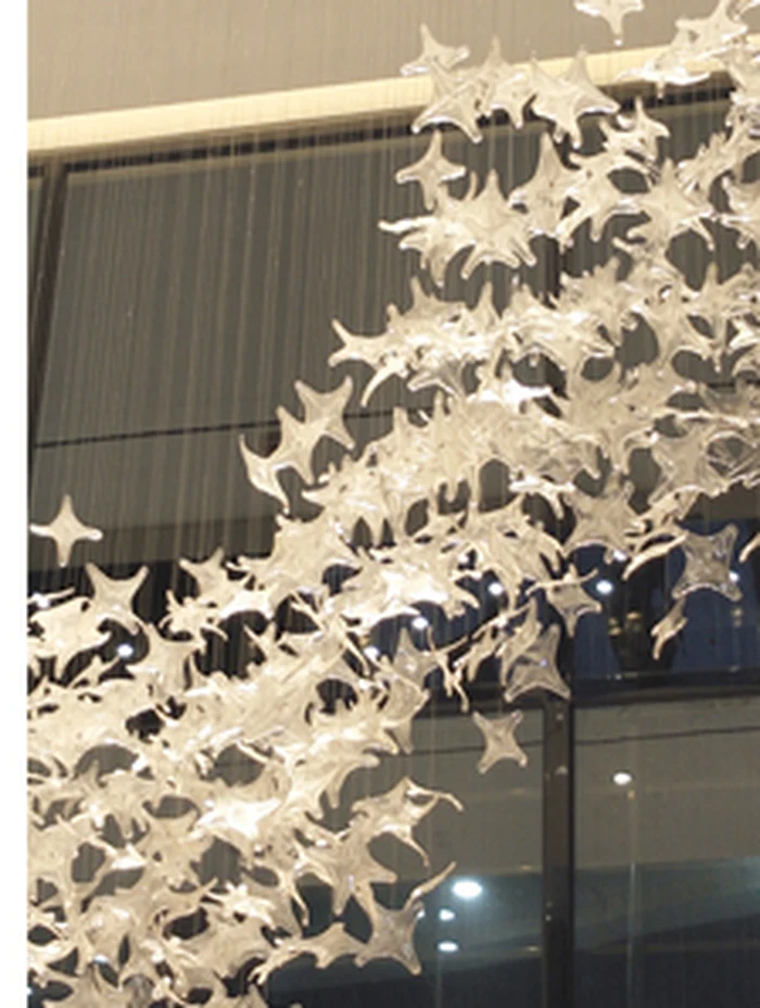 Close view of the white leaf elements in the lobby light installation