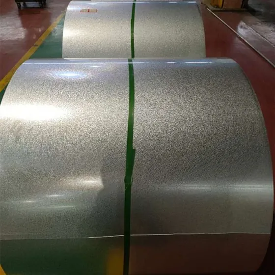 Galvanized steel coils secured with green strapping bands on a factory floor