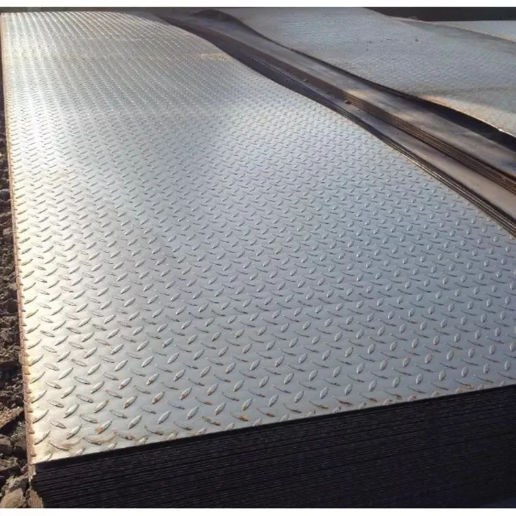 Stacked diamond-pattern steel checker plates on bare ground, some edges showing rust