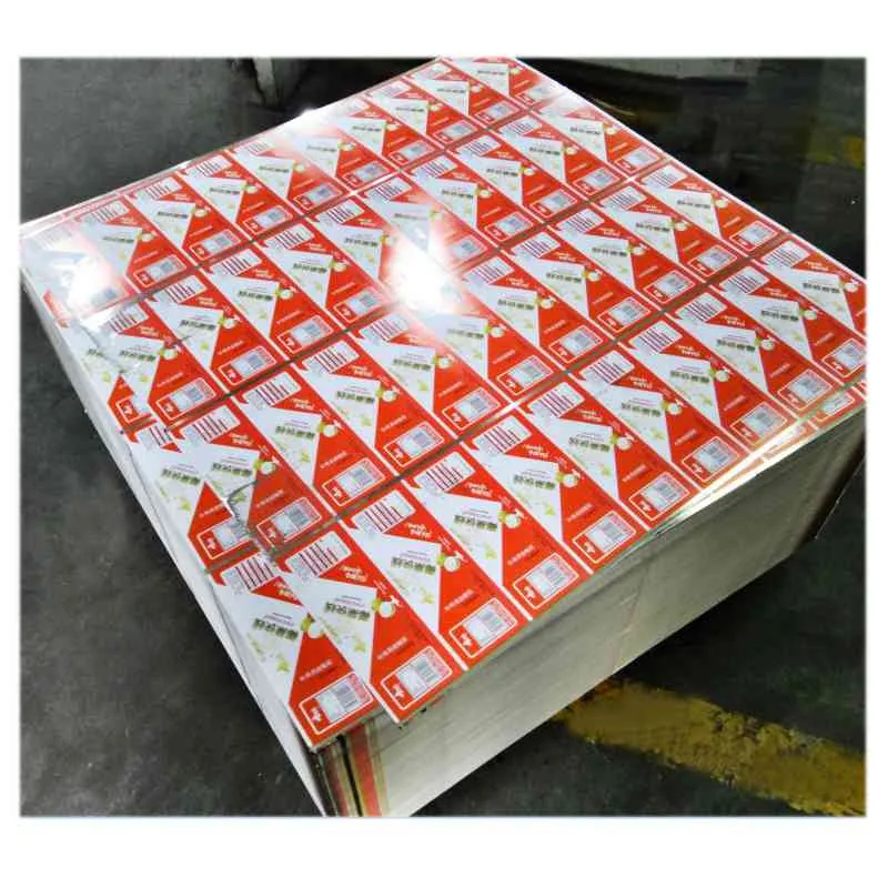 Large stack of printed red and white packaging box blanks on a pallet in a factory