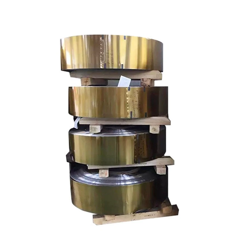 Stack of golden-colored metal strip coils resting on wooden pallets against a white background