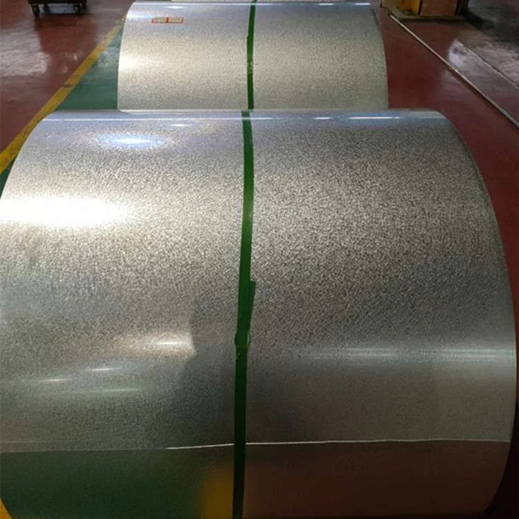 Galvanized steel coils secured with green strapping bands on a factory floor