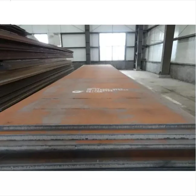 Stacked weathering steel plates with white stenciled mill markings inside a warehouse