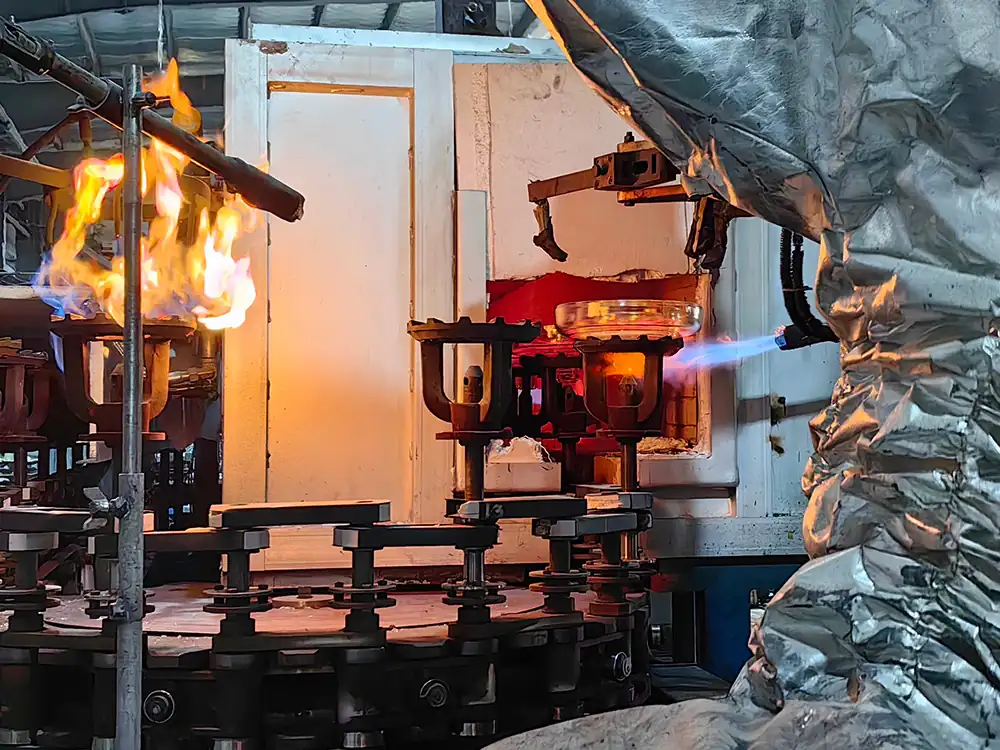 Freshly pressed glass insulator shells passing through the homogenization furnace