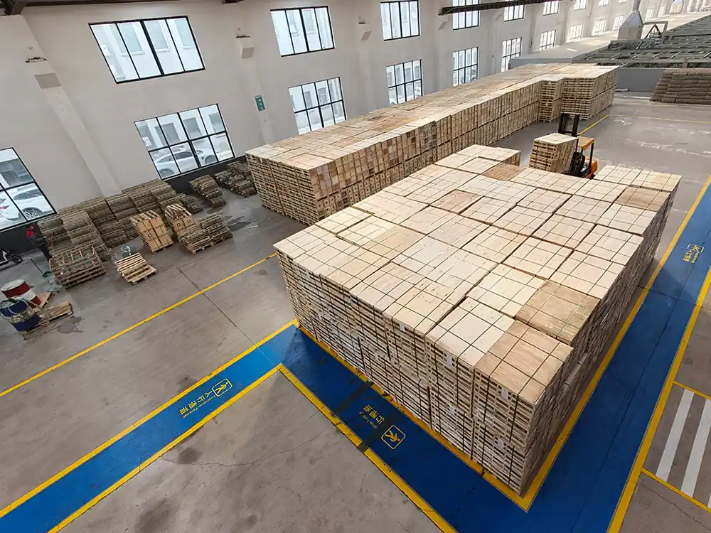 Toughened glass insulators packed in export crates on pallets in the finished goods warehouse