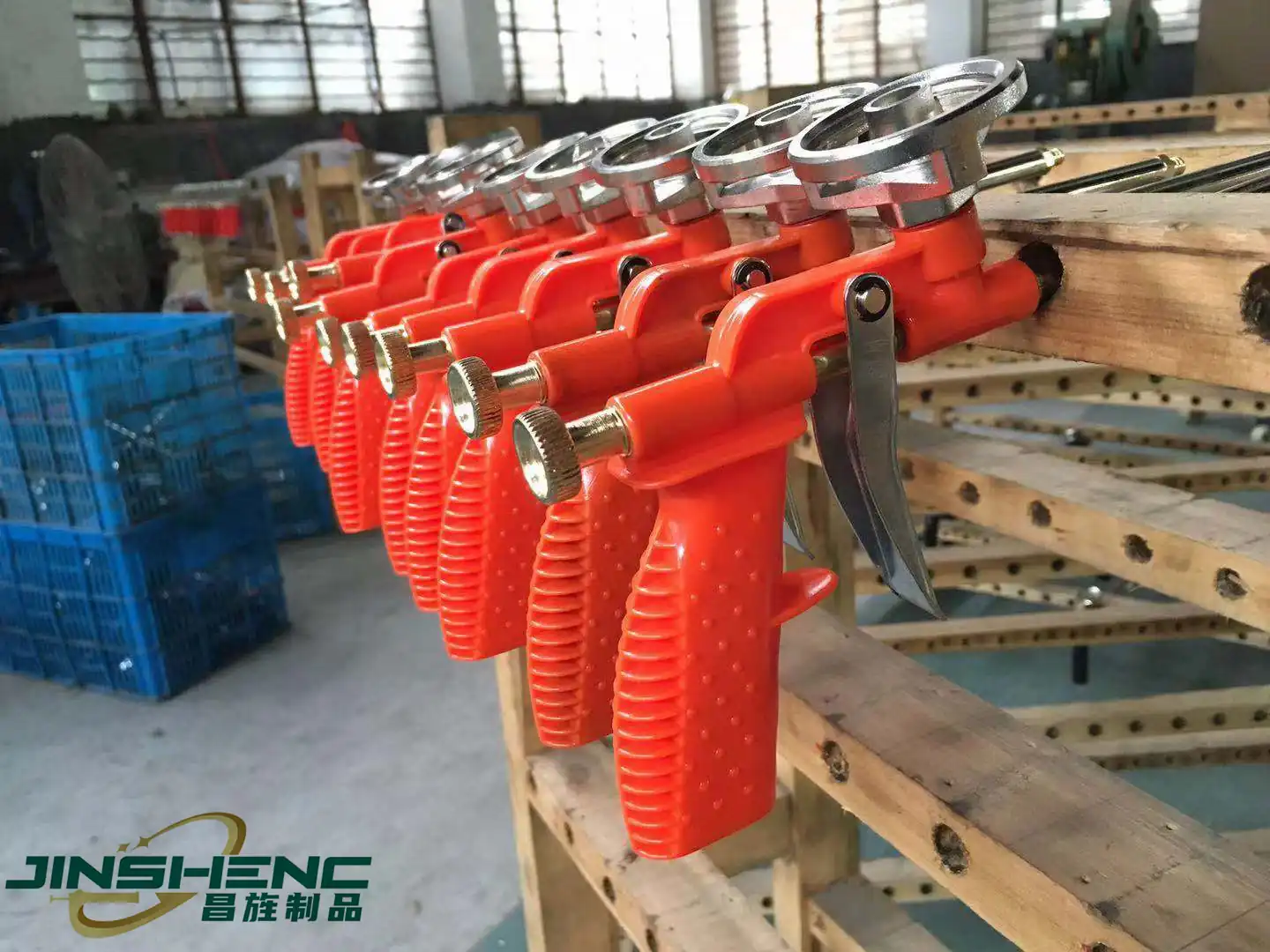 Rows of orange PU foam gun bodies lined up on the assembly bench during production