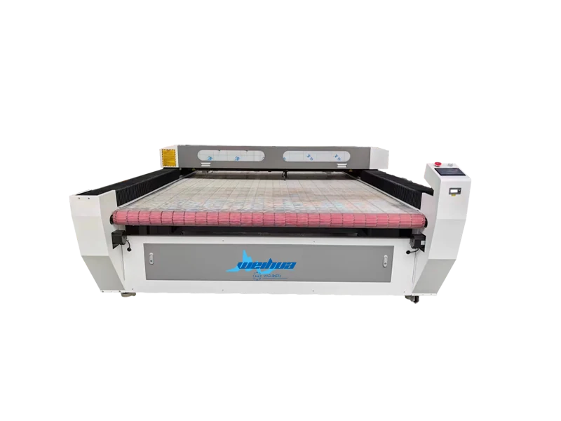Auto feeding laser cutting machine processing a roll of material
