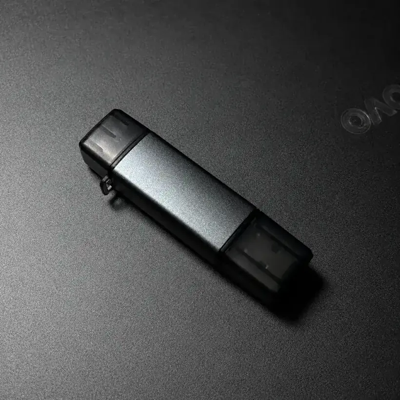 Aluminium 2-in-1 SD and microSD card reader photographed on a dark surface