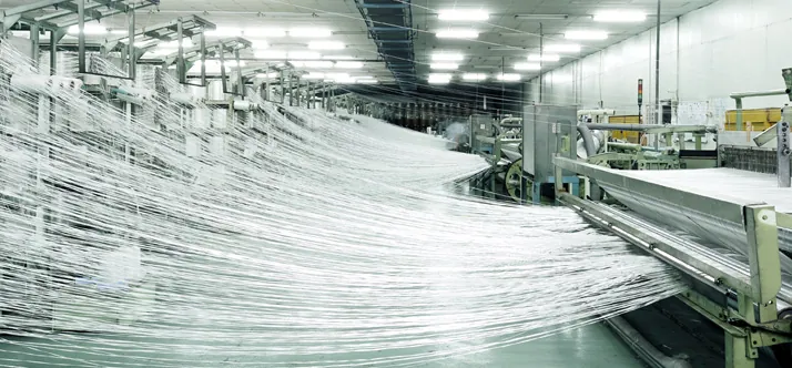 Fiberglass yarn running through the production line