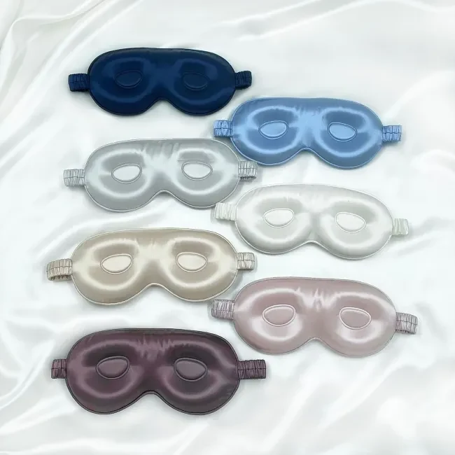 3D silk sleep mask laid flat showing the contoured eye cover and adjustable strap