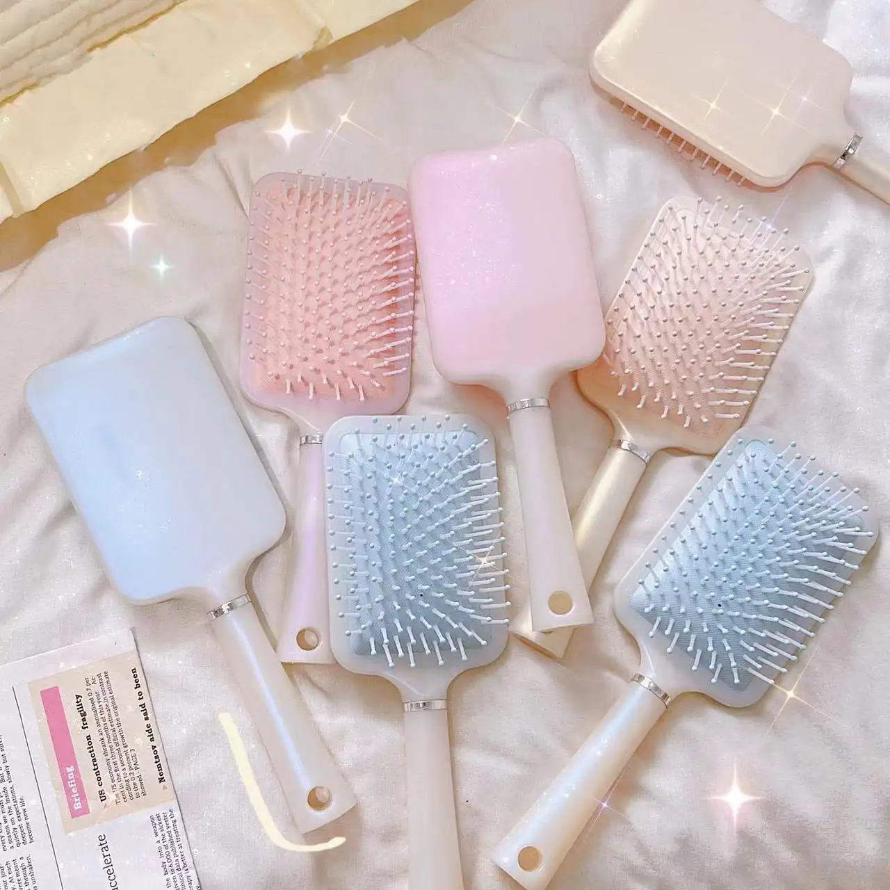 Air cushion comb with soft bristles laid flat on a white surface