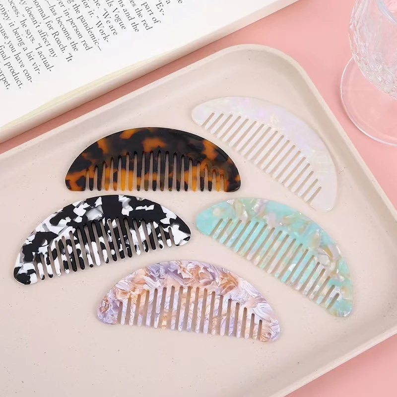 Cellulose acetate arch hair comb with rounded teeth, showing the smooth crystal-like surface