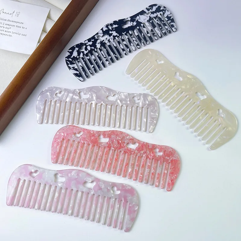 Cellulose acetate round tooth comb with a crystal-like finish laid flat