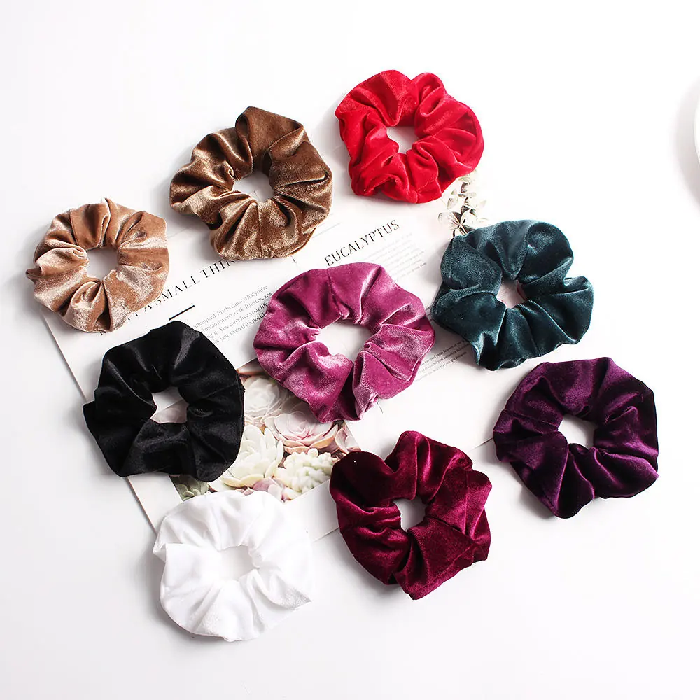 Set of solid colour flannel hair scrunchies laid out flat on a white surface