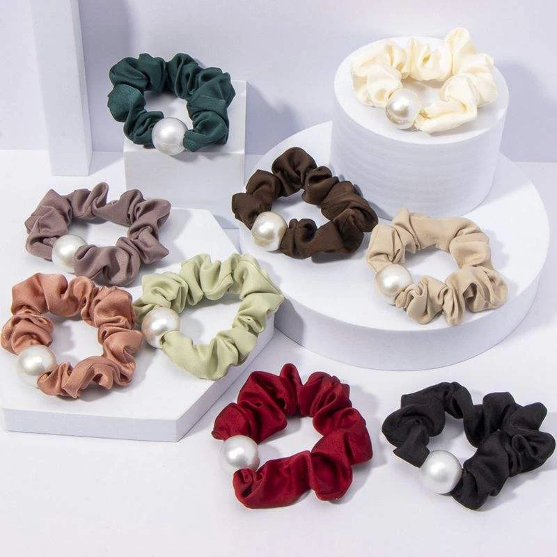 Large satin hair tie with pearl accent laid flat